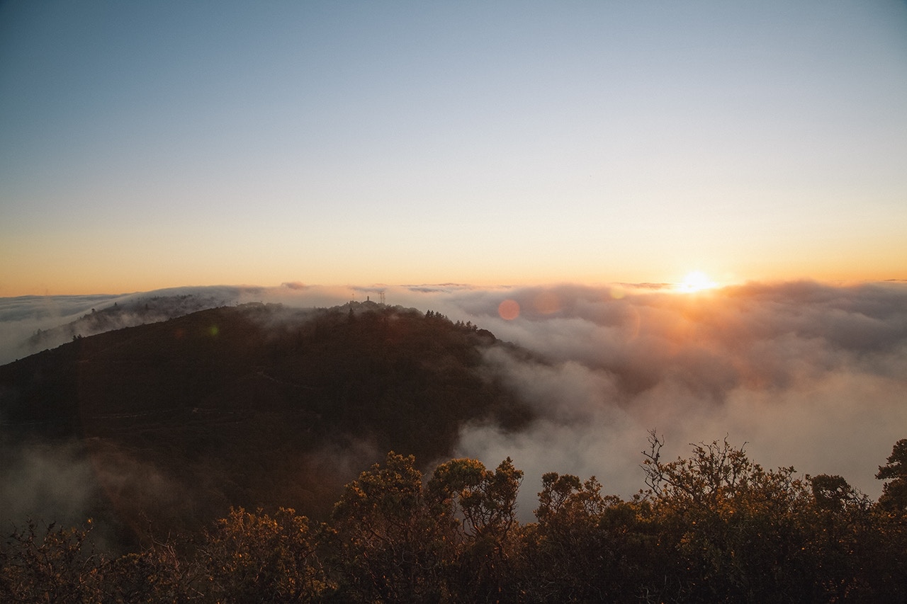 Sunrise over foggy hills